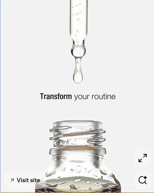 Glass dropper releasing a drop of clear serum into an open bottle